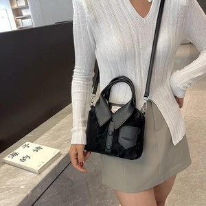 Minimalist black shirt-shaped crossbody bag with collar and button details