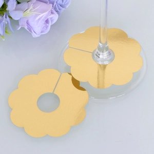 Golden floral wine glass place cards with metallic finish for festive party decorations