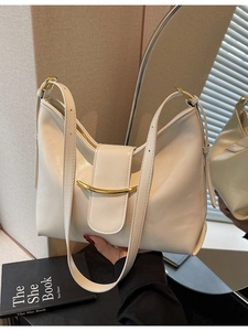 Minimalist beige Hobo bag with gold hardware and adjustable strap for daily use