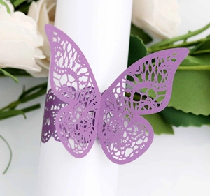 Macro detail of laser-cut butterfly napkin ring in light purple pearlescent paper