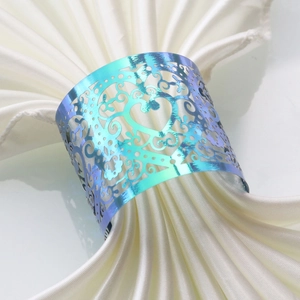 Detail of gradient heart napkin ring with laser-cut hollow patterns for wedding decor