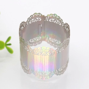 Detailed laser-cut hollow lace cupcake wrapper with rainbow holographic finish