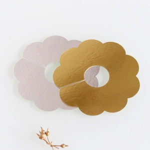 Detail of petal-shaped wine glass cards in matte lavender and glossy metallic gold