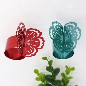 Detailed close-up of hollow butterfly floral napkin rings with bright metallic finish