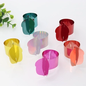 Macro detail of multi-color metallic autumn leaf napkin rings on white background