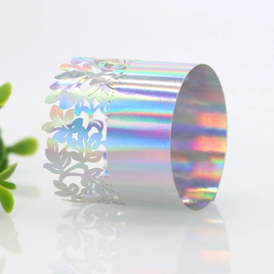 Macro detail of laser-cut iridescent napkin ring with floral pattern for weddings