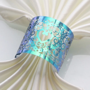 Macro shot of iridescent laser heart napkin ring with intricate hollowed patterns