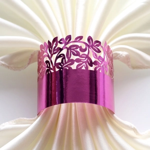 Close-up of laser-cut rose purple paper napkin ring with elegant leaf pattern