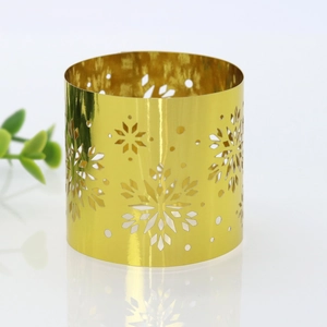 Close-up of golden hollow snowflake napkin ring with polished metallic finish for tables