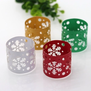 Macro view of Christmas snowflake paper napkin rings in gold, silver, red, and green