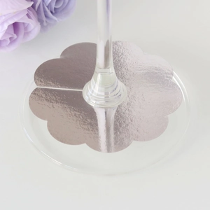 Detail of silver flower wine glass base ring charm for festive table seating and decoration