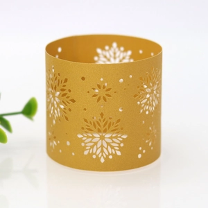 Detailed view of golden snowflake laser-cut paper napkin ring for Christmas table decor