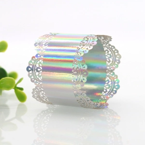 Detail of holographic laser-cut lace napkin ring showing iridescent luster and reflection