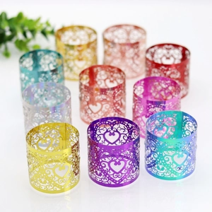 Detailed close-up of colorful heart laser-cut metal napkin rings in various vibrant finishes