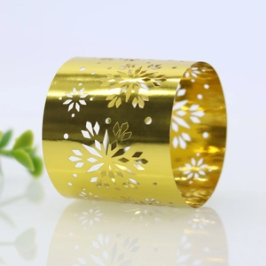 Close-up of golden hollow snowflake napkin ring with metallic mirror finish for tables