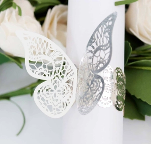 Macro view of gold lace butterfly napkin ring with laser-cut hollow pattern for weddings