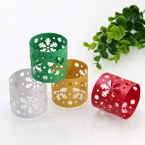 Detailed laser-cut snowflake napkin rings in festive gold, silver, red and green colors