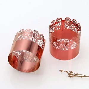 Macro shot of rose gold lace hollowed-out napkin rings with elegant floral patterns
