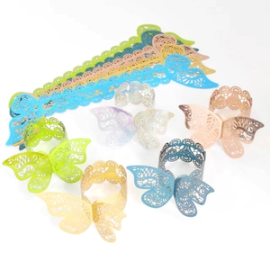 Detail of laser-cut paper butterfly napkin rings in various pastel colors for decor