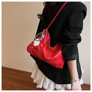 Detail of red pebbled leather Hobo bag with 3D elephant charm and silver bead chain