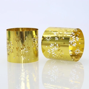 Close-up of shiny gold snowflake cut-out napkin rings for Christmas table decor
