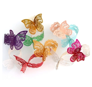 Close-up of laser cut butterfly napkin rings in assorted metallic pearlescent colors