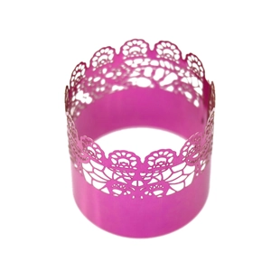 Close-up of fuchsia laser-cut lace napkin ring with hollow floral pattern detail