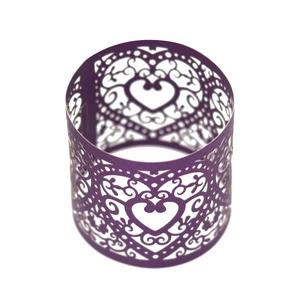 Macro detail of purple laser-cut heart pattern on a decorative paper napkin ring