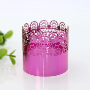 Detail of rose pink laser-cut cupcake wrapper with elegant lace lace pattern and metallic finish