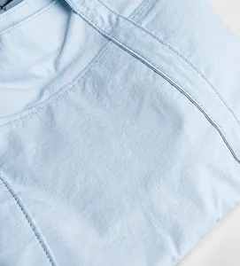 Detail of light blue lightweight nylon fabric with clean parallel stitching texture