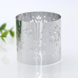 Close-up of laser-cut silver snowflake napkin ring with a polished mirror finish