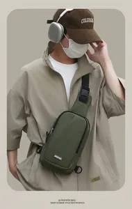 Detail of army green nylon chest bag with adjustable strap and brand logo patch