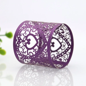 Detail of laser-cut heart pattern napkin ring in purple for wedding table decor