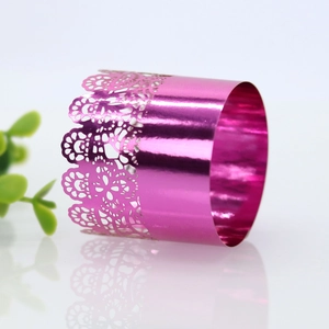 Macro view of pink laser-cut lace napkin ring with a reflective metallic finish