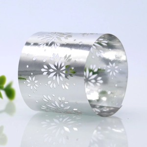 Close-up of silver hollowed snowflake napkin ring with metallic luster and reflections