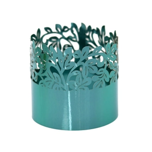 Detail of laser-cut teal napkin ring with intricate leaf pattern for wedding events