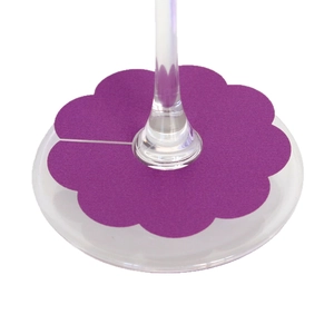 Purple flower shaped wine glass markers made of cardstock for wedding party place names