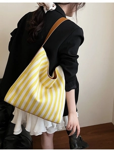 Chic yellow and white striped canvas tote bag with slim brown leather straps