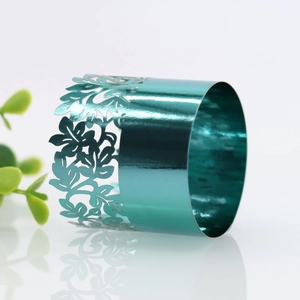 Detailed laser-cut floral pattern napkin ring in shiny teal metallic finish for weddings