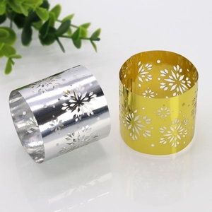 Detailed view of silver and gold snowflake hollow napkin rings with a mirror finish