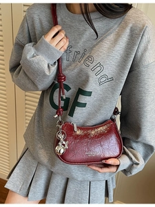 Retro burgundy patent leather crossbody bag with silver bear charm and shoulder strap