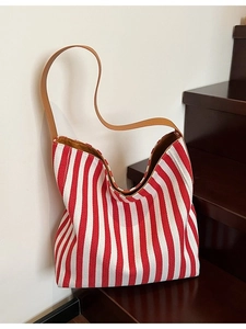Minimalist red and white striped canvas tote bag with brown leather strap and yellow lining