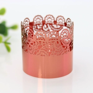 Detail of rose gold laser-cut lace napkin ring with elegant floral hollow pattern