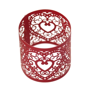 Close-up of red laser-cut heart pattern paper napkin ring for wedding table decor