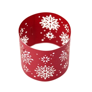 Detail of red laser-cut snowflake napkin ring with intricate hollowed-out festive patterns