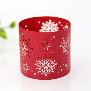 Detail of red laser-cut snowflake paper napkin ring for Christmas table decor