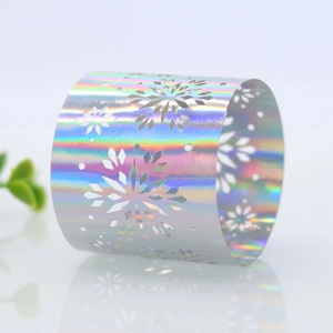 Detail of silver iridescent laser-cut napkin ring featuring an hollow snowflake design