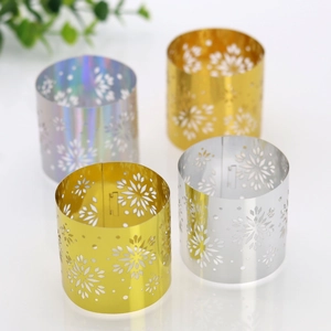 Detail of laser-cut snowflake napkin rings in gold, silver, and holographic finishes