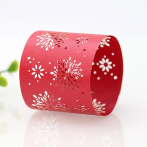 Macro detail of red laser-cut snowflake napkin ring for Christmas dinner party decor