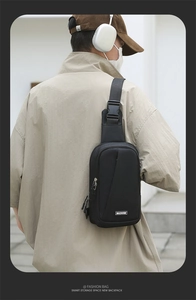 Macro detail of men's waterproof nylon chest bag featuring adjustable strap and buckle